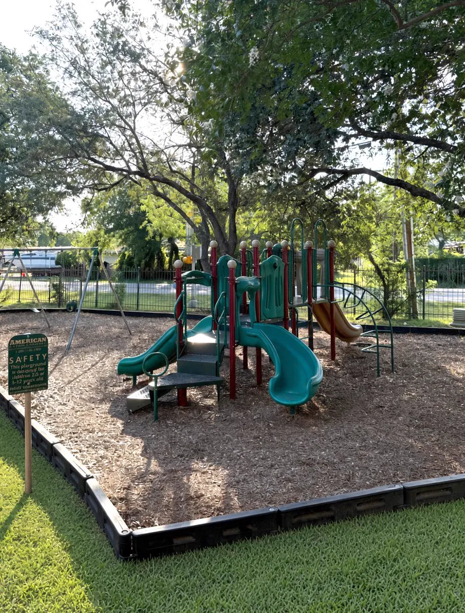 On-site children's playground at Wilshire Woods Apartments