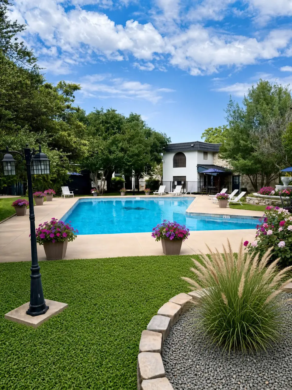Wide view of a swimming pool at Wilshire Woods Apartments